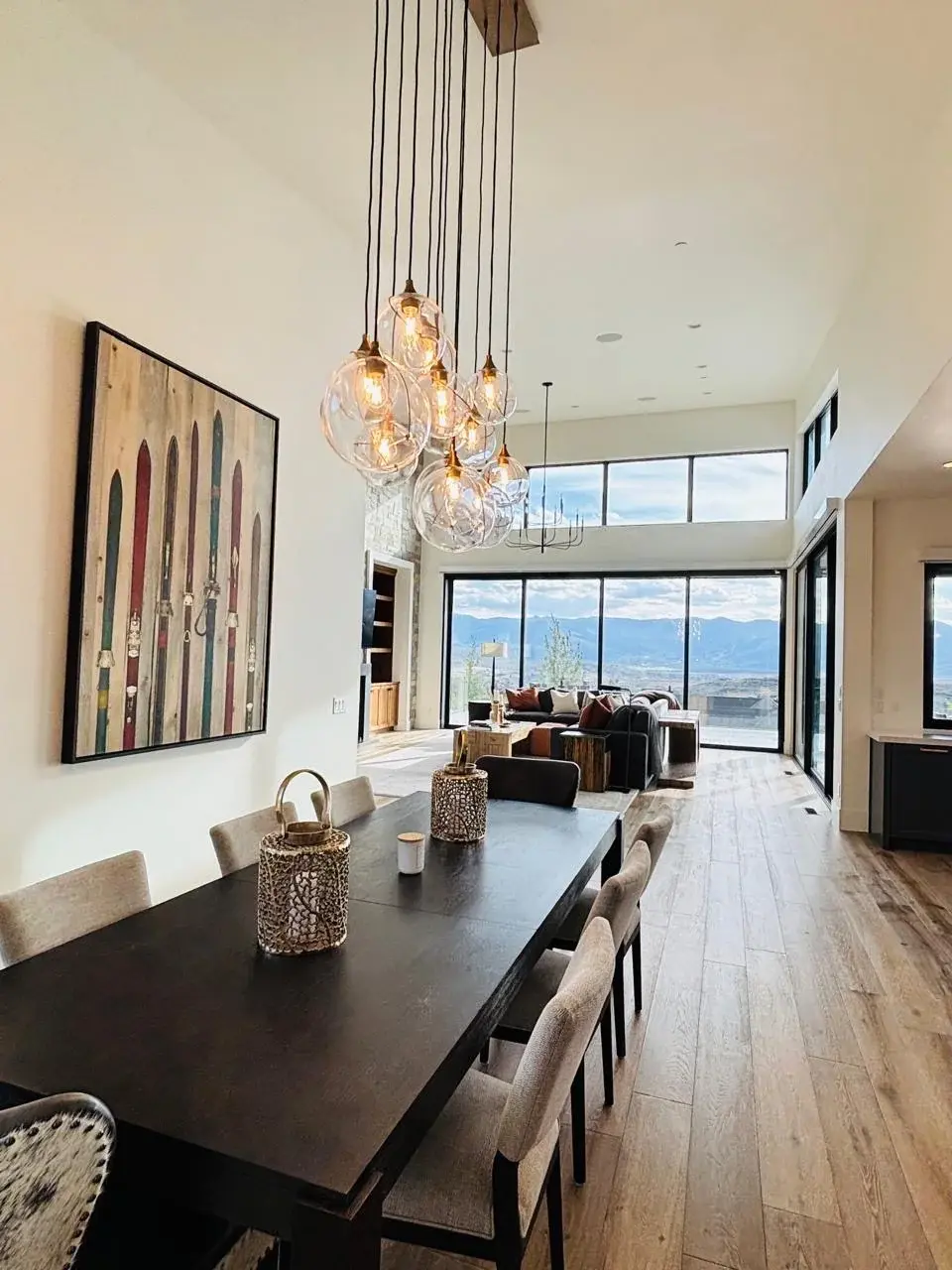 Open dining and living space with a glass pendant chandelier and mountain views