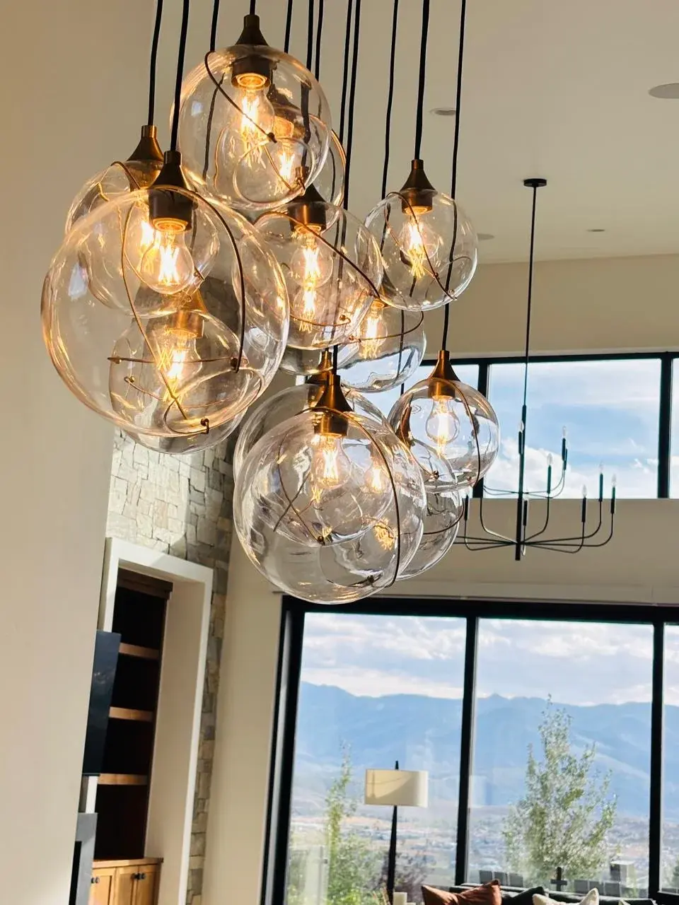 Warm glass pendant lights over a bright living space
